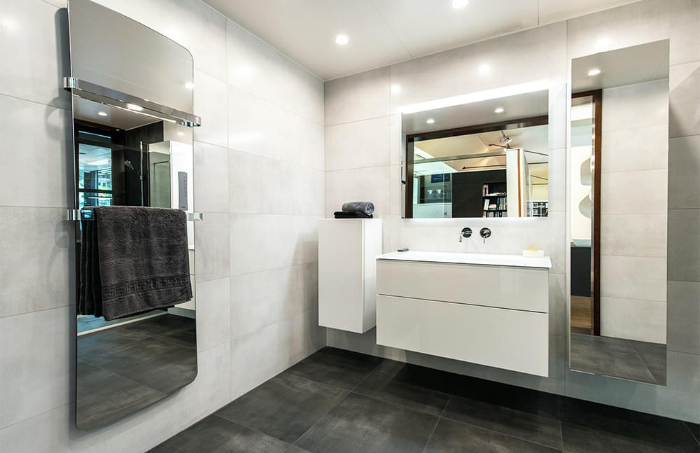 Schauraum, Badezimmer, Spiegelschrank, großformatige Fliesen, Waschtisch mit Einbauwaschbecken, Handtuchwärmer